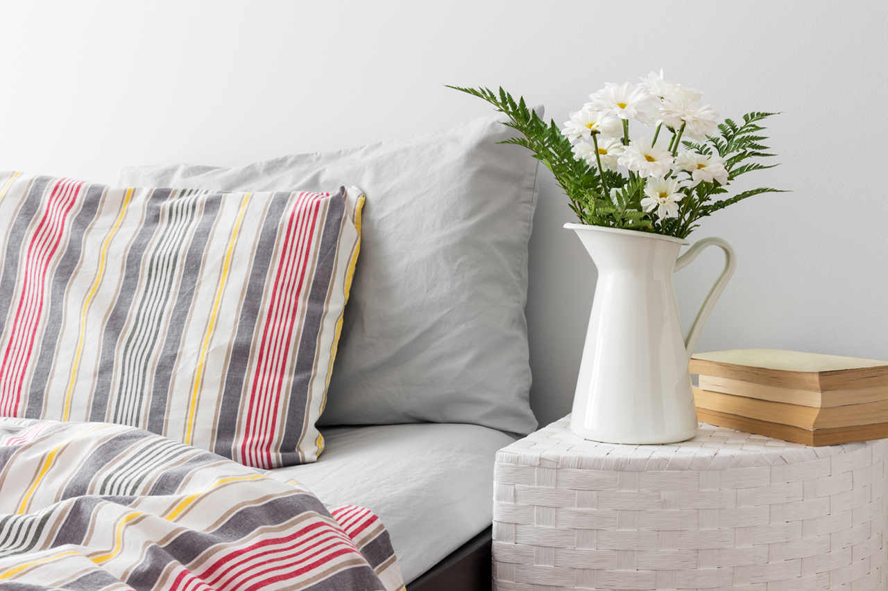 White-flowers-and-books-on-a-bedside-table